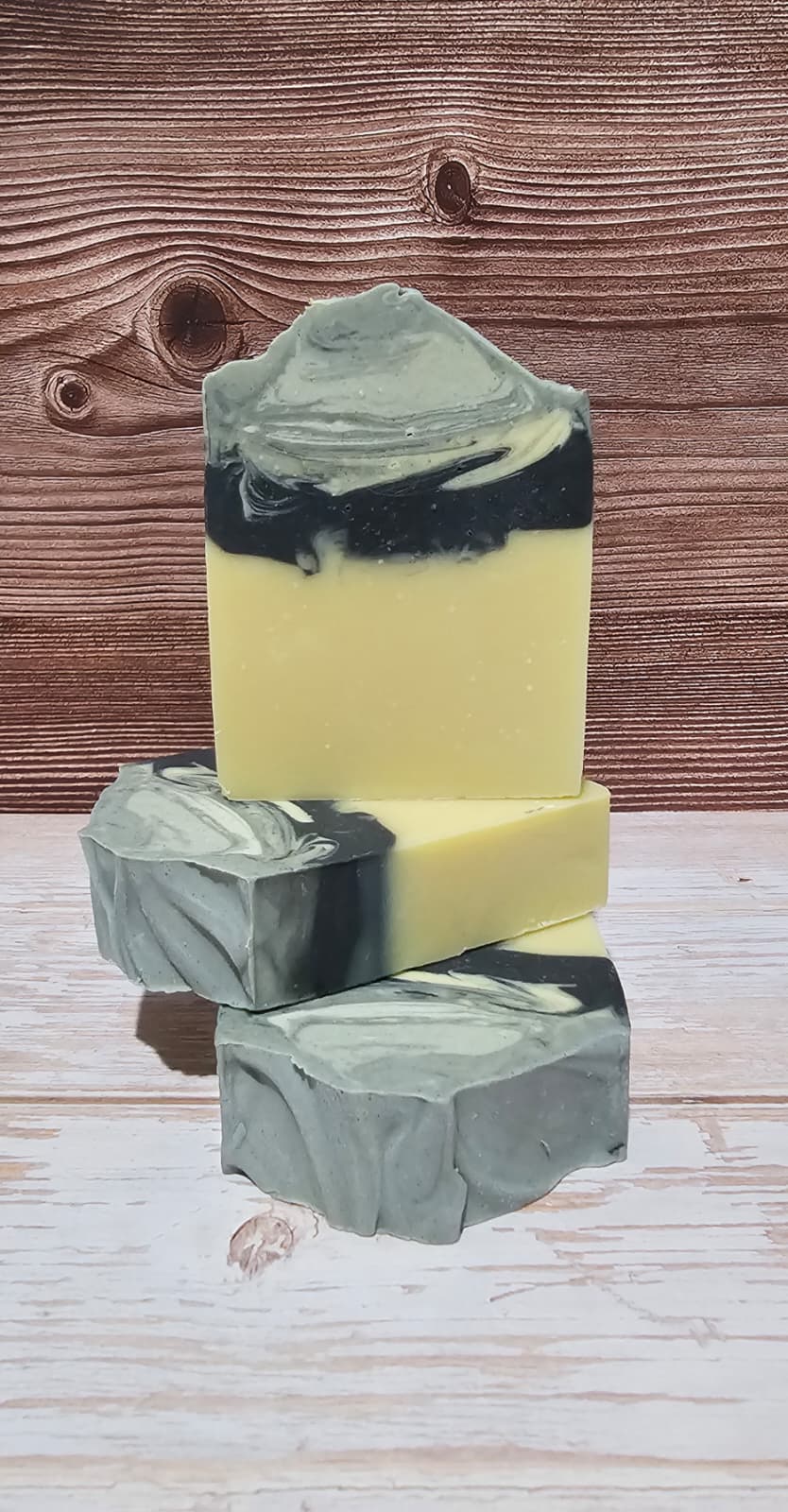 Three layered soap bars on a wooden surface