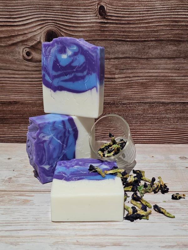 Butterfly pea flower soap with a wooden background