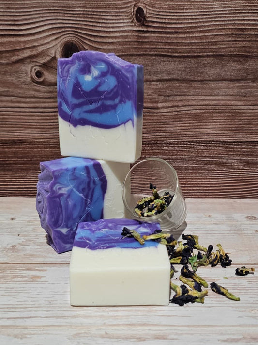 Butterfly pea flower soap with a wooden background