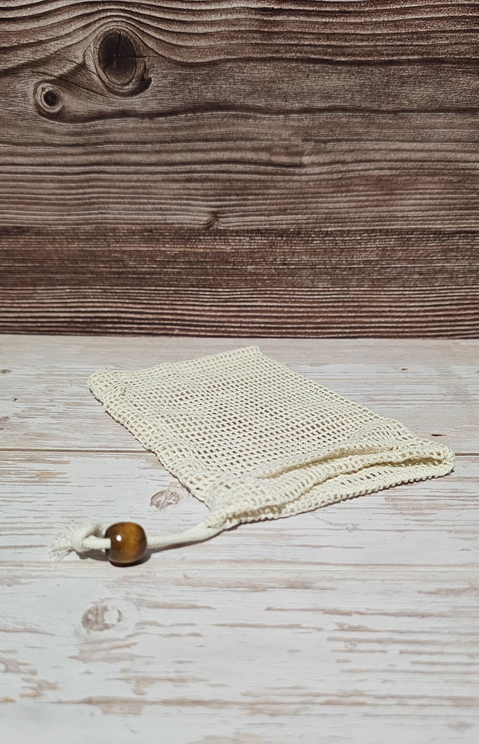 Cotton soap saver on top of a wood surface.