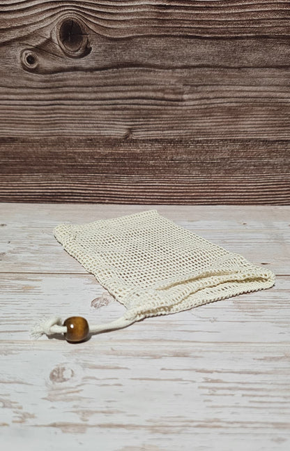 Cotton soap saver on top of a wood surface.