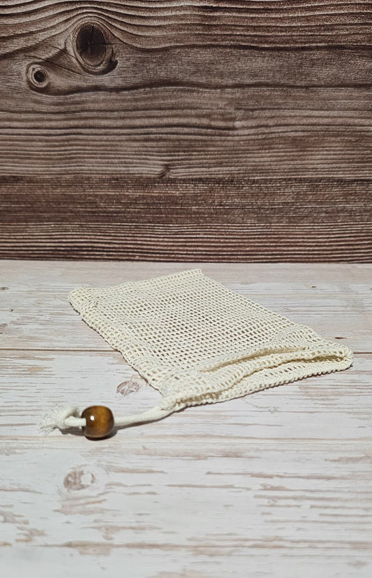 Cotton soap saver on top of a wood surface.