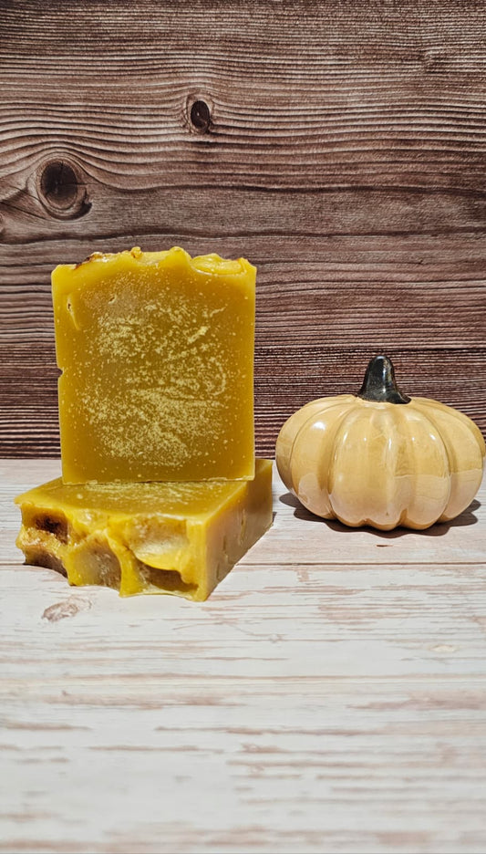 2 bars of soap with a small pumpkin on a wooden surface