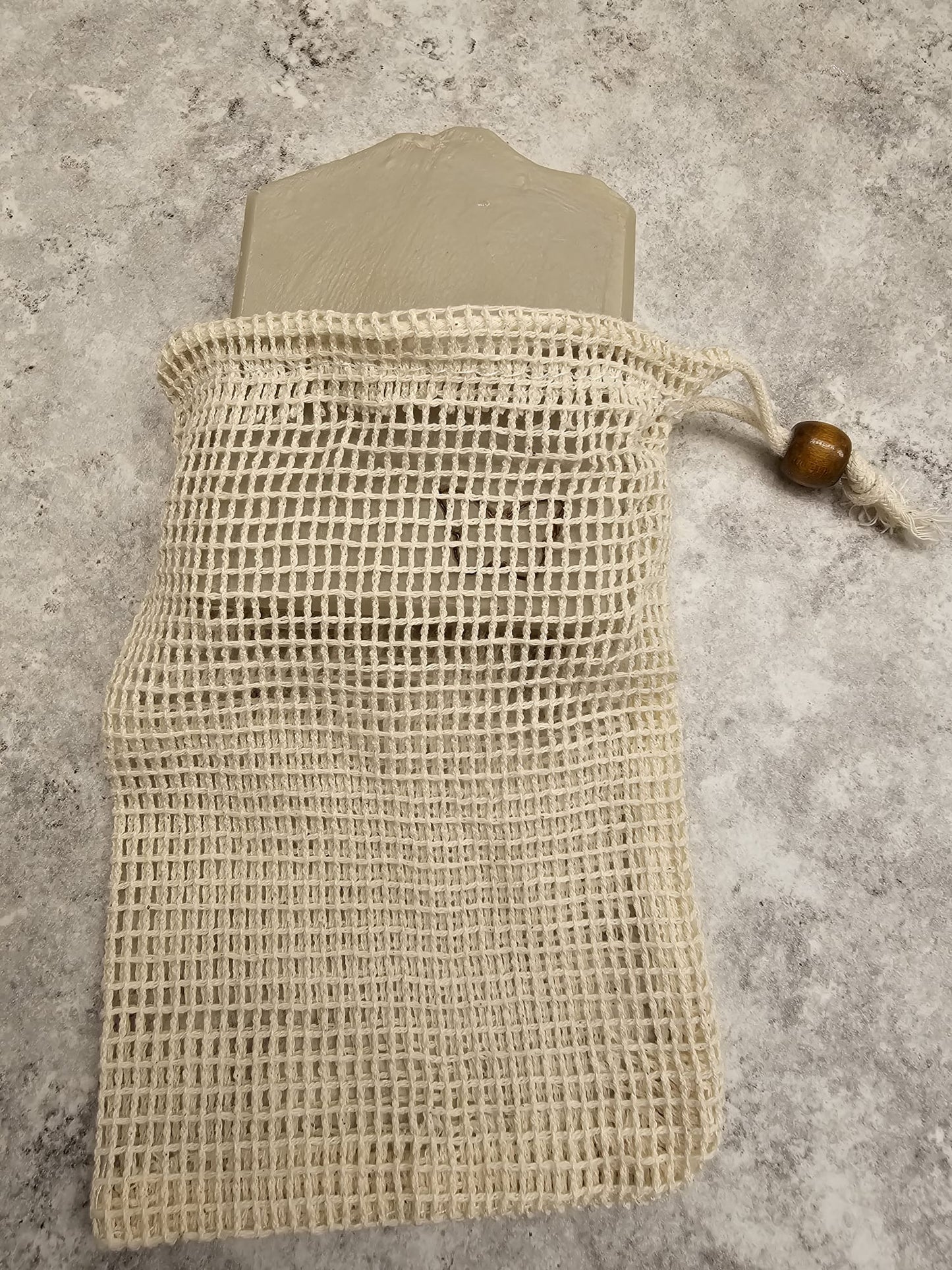 Beige mesh bag on a textured gray surface